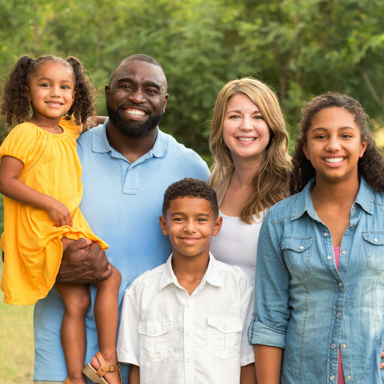 Portrait of a mixed race family laughing.