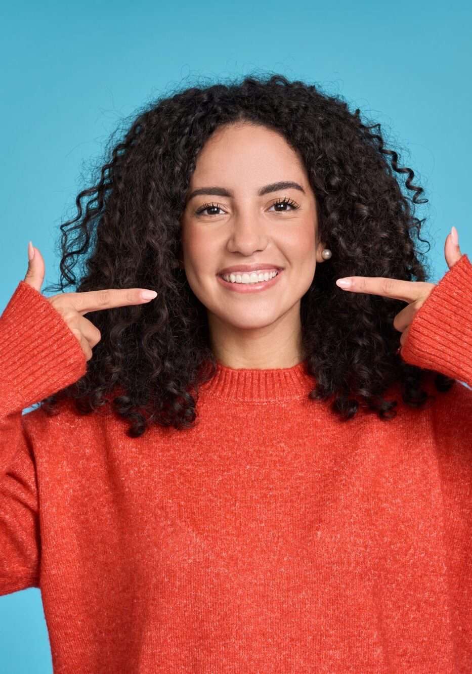 "Happy,Young,Latin,Woman,Pointing,At,White,Healthy,Teeth,,Showing"